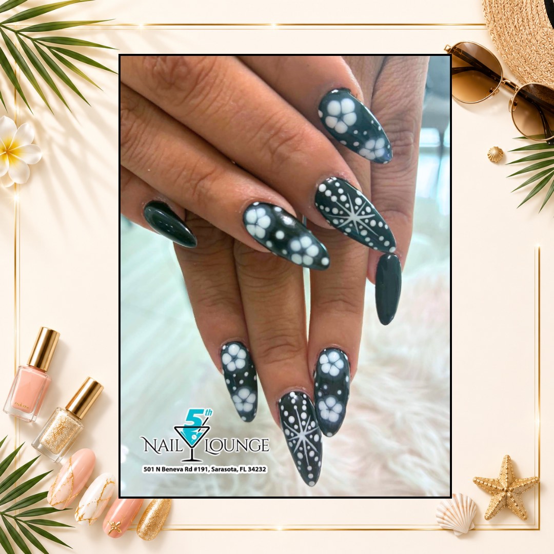 Hand-painted floral nail art in emerald green with delicate white blossoms