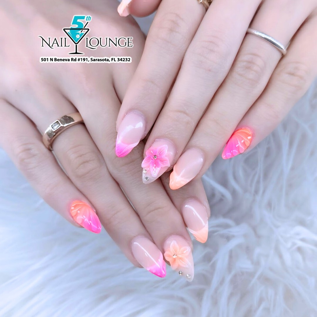 Pink and orange ombre nails with gold foil accents on almond shape
